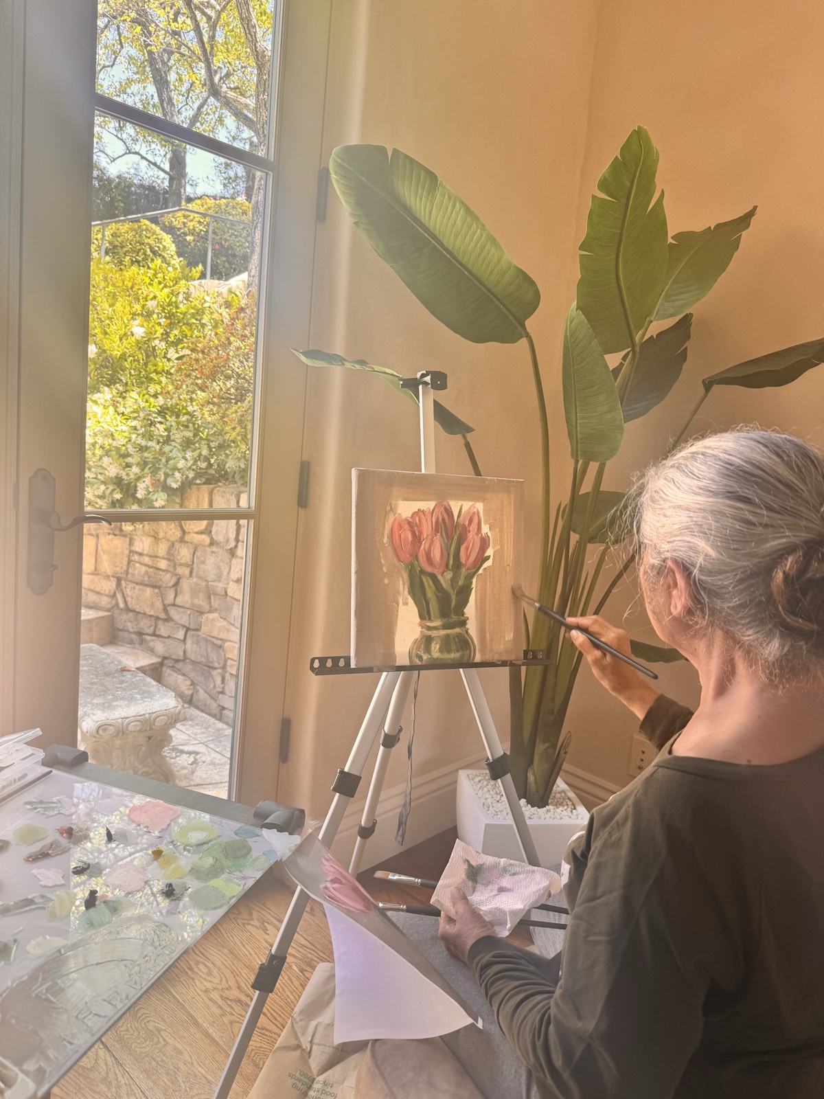 A student working on a still life of oranges