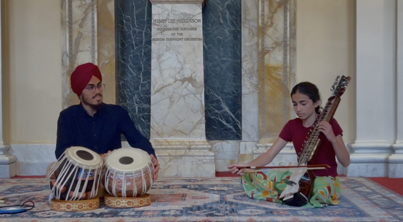 Parnaz playing dilruba while her brother plays tabla