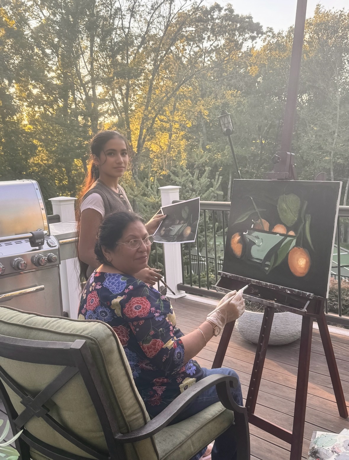 The same student mid-painting, glancing up at the camera