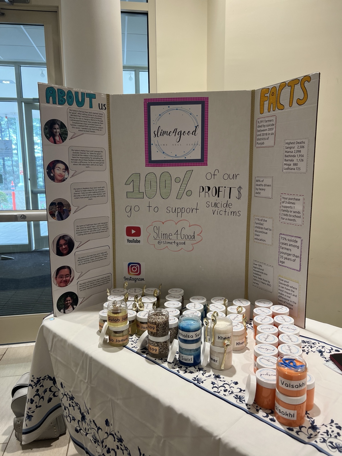 Slime for Good fundraiser table with the project's info board